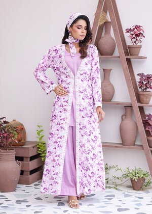 Woman wearing a floral dress and headscarf in a room with shelves and plants.