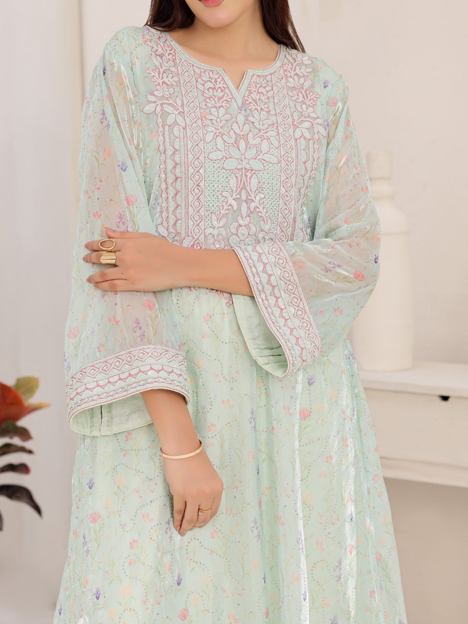 Wide embroidered cuffs on mint organza dress